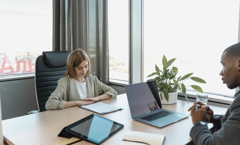 Recruiter reviewing resumes at a desk in a regional staffing office