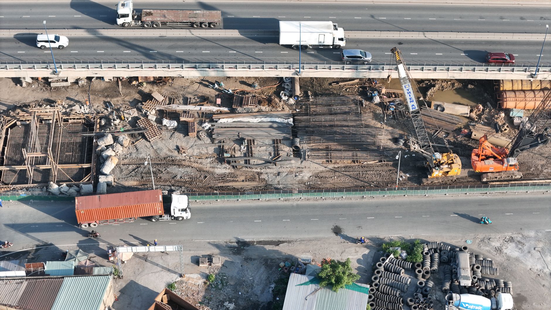 Aerial view of a large commercial construction site with cranes and building frameworks
