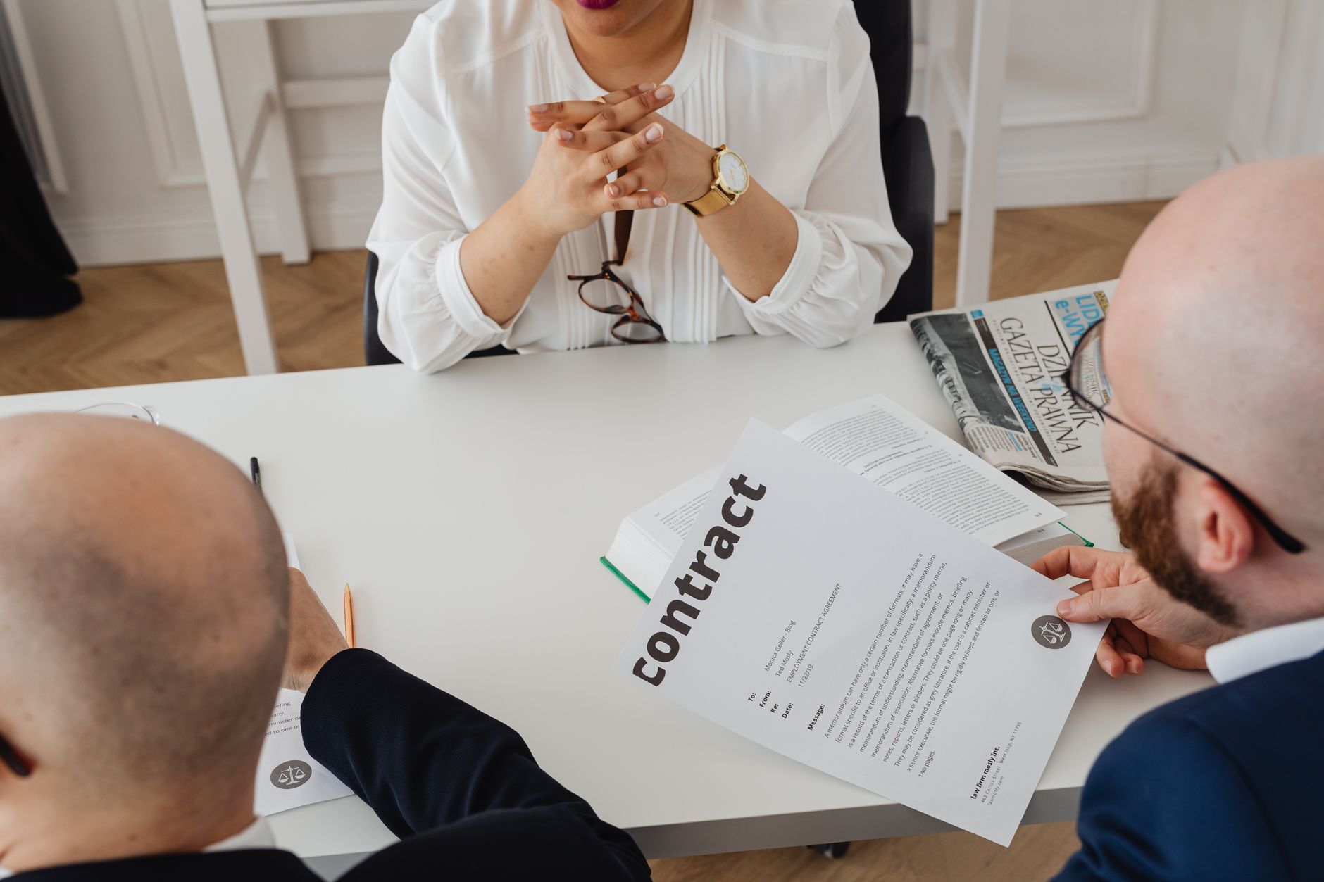 Business professionals reviewing contracts at a meeting table representing private equity acquisitions