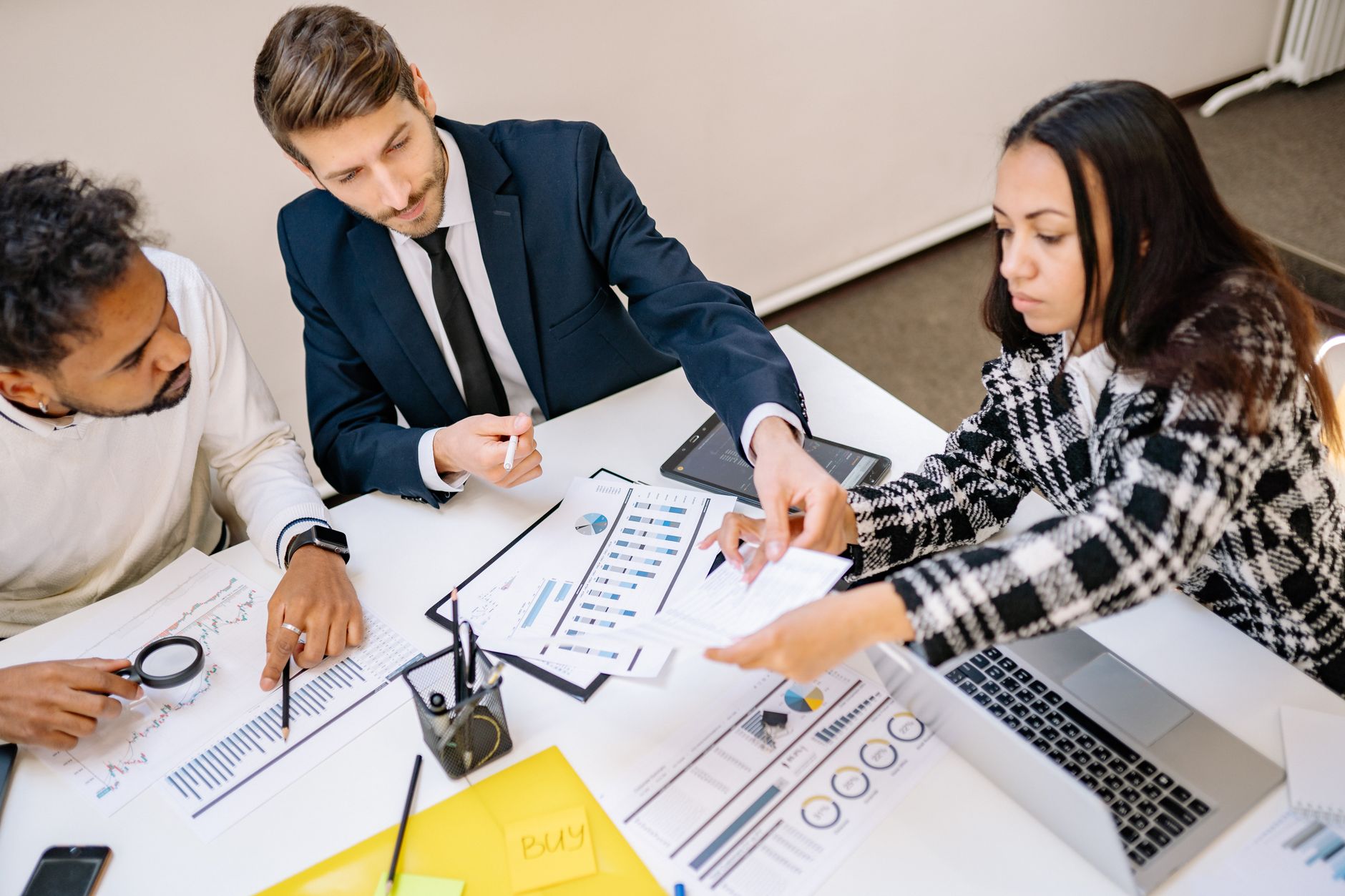 Professionals reviewing documents and financial data during a business meeting