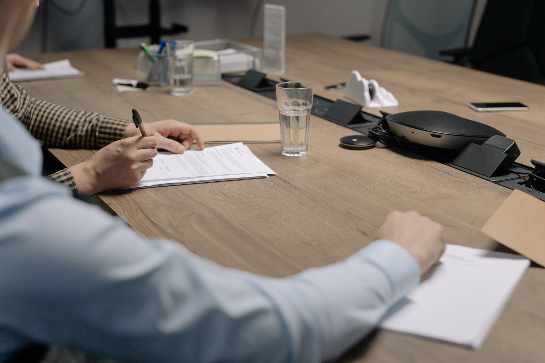 Two professionals reviewing financial documents across a desk