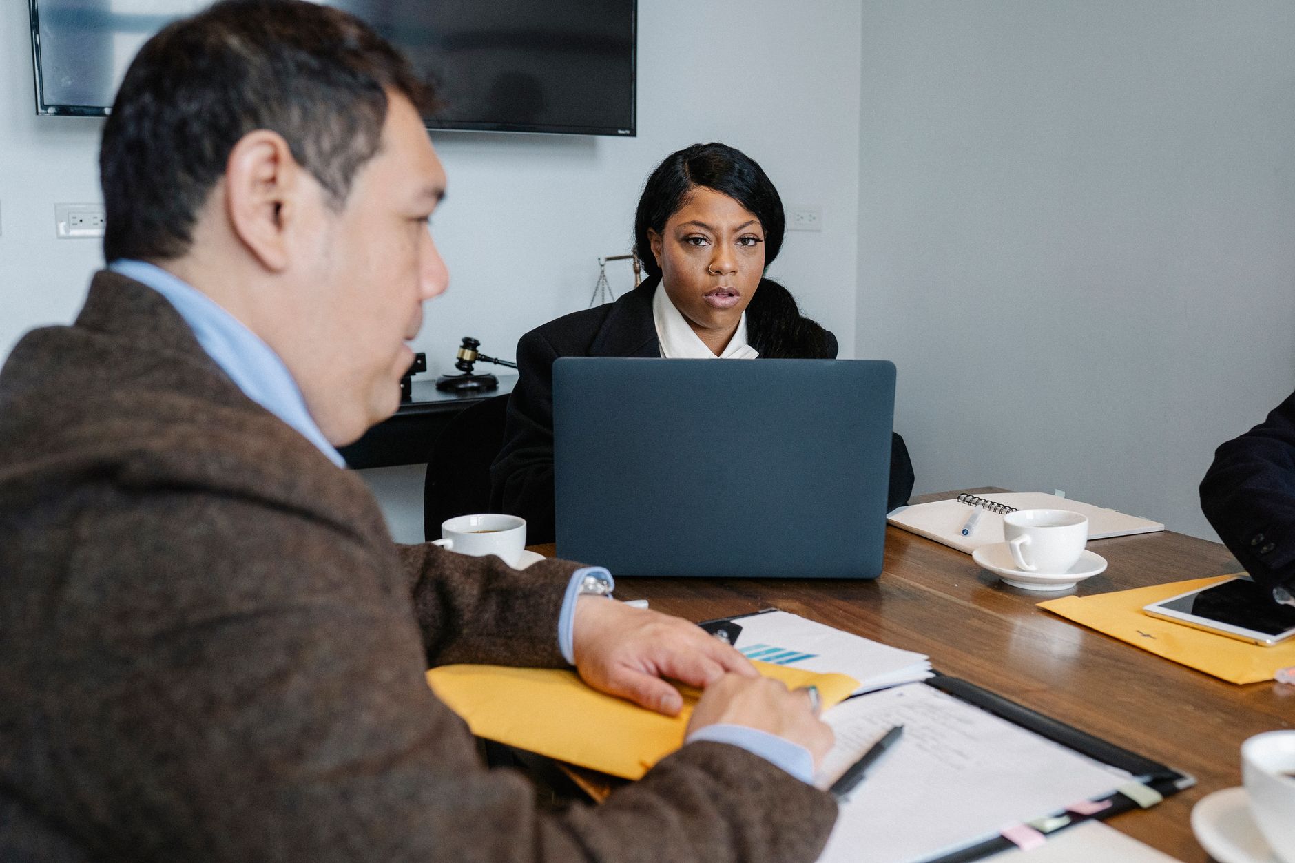 Business professionals reviewing documents during a corporate acquisition meeting