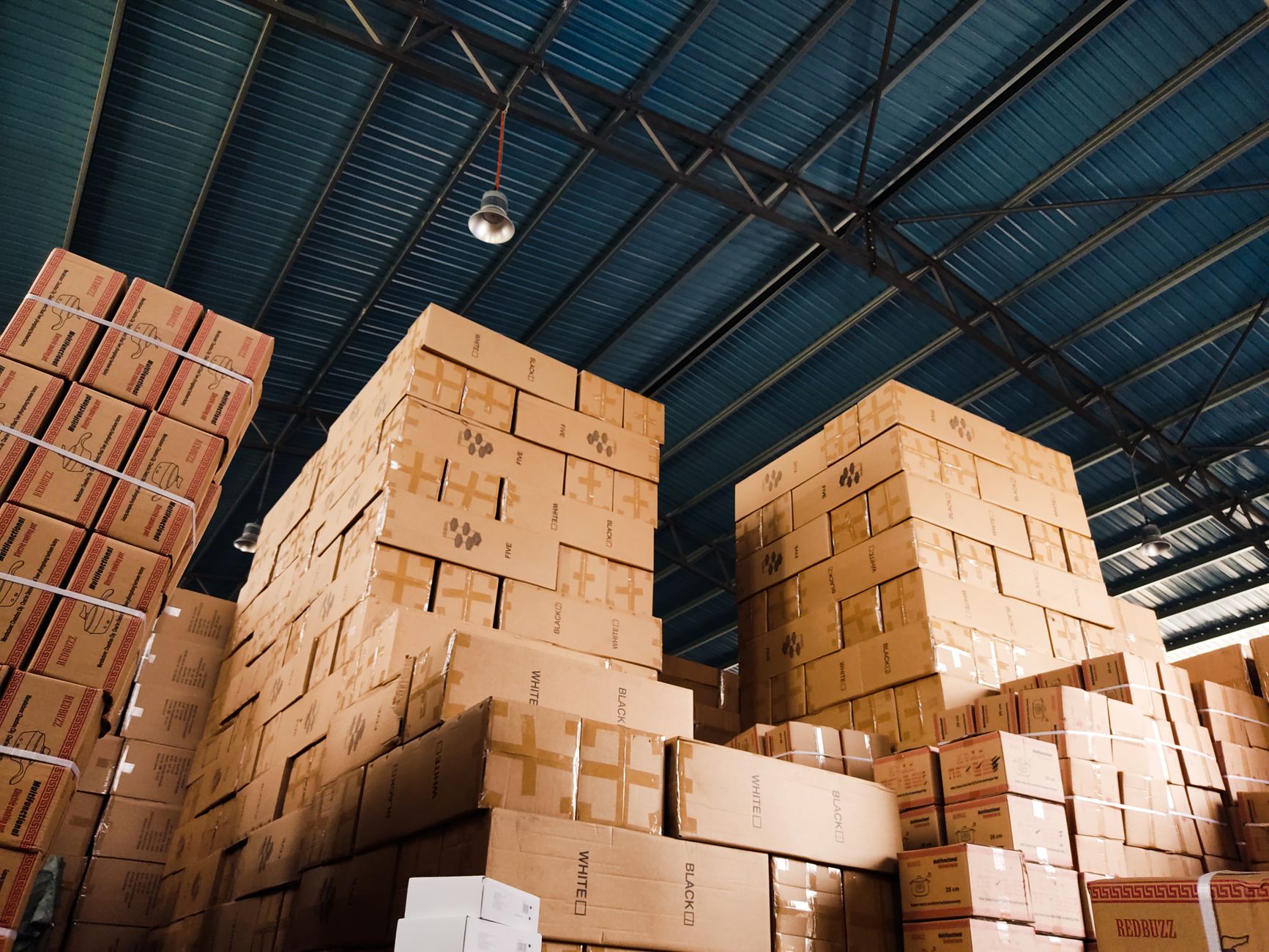 Interior of a commercial logistics warehouse with vehicles and equipment