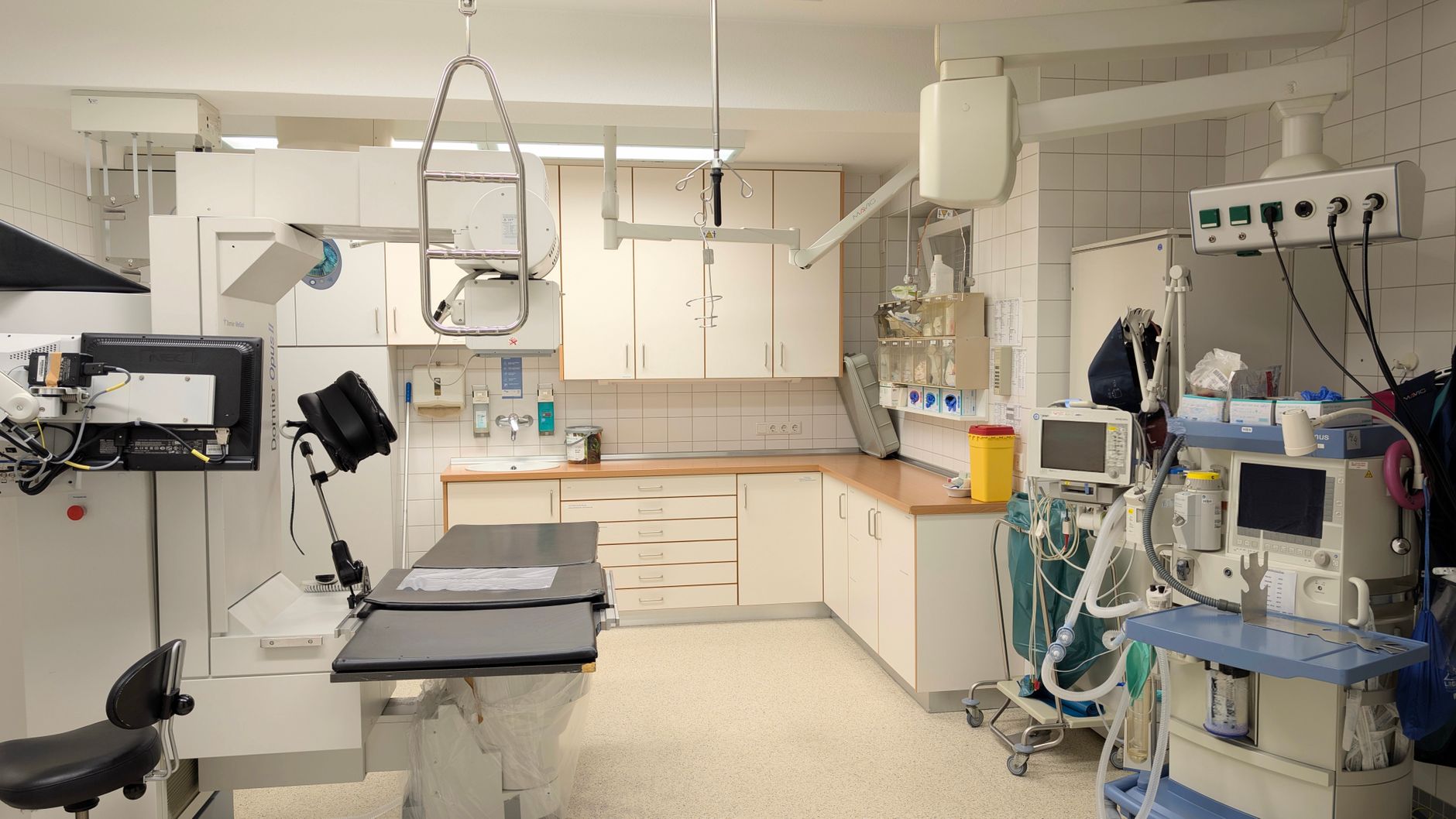 A room with hospital beds and medical equipment stacked and organized for distribution