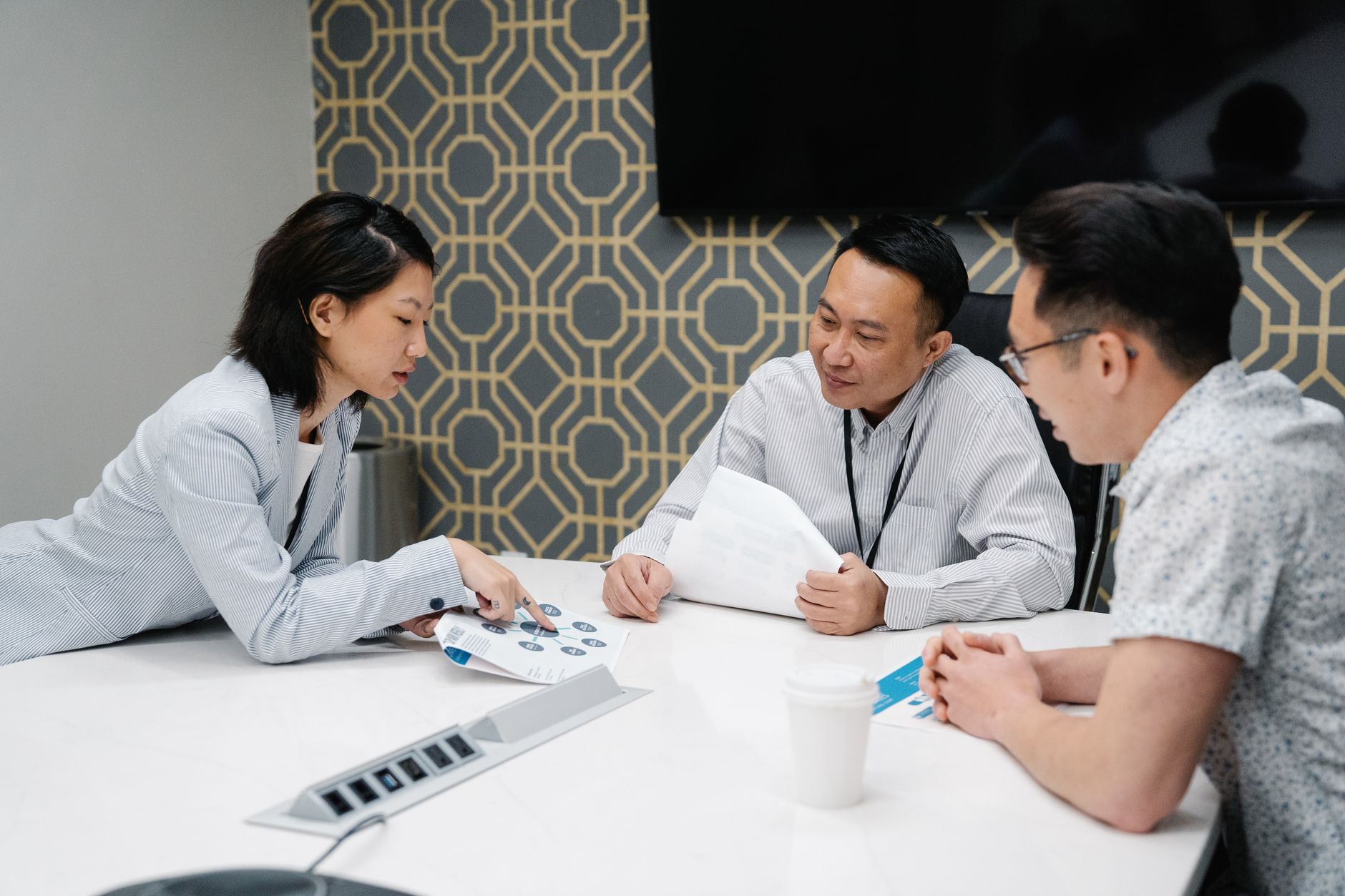 Healthcare administrators reviewing documents in a hospital conference room