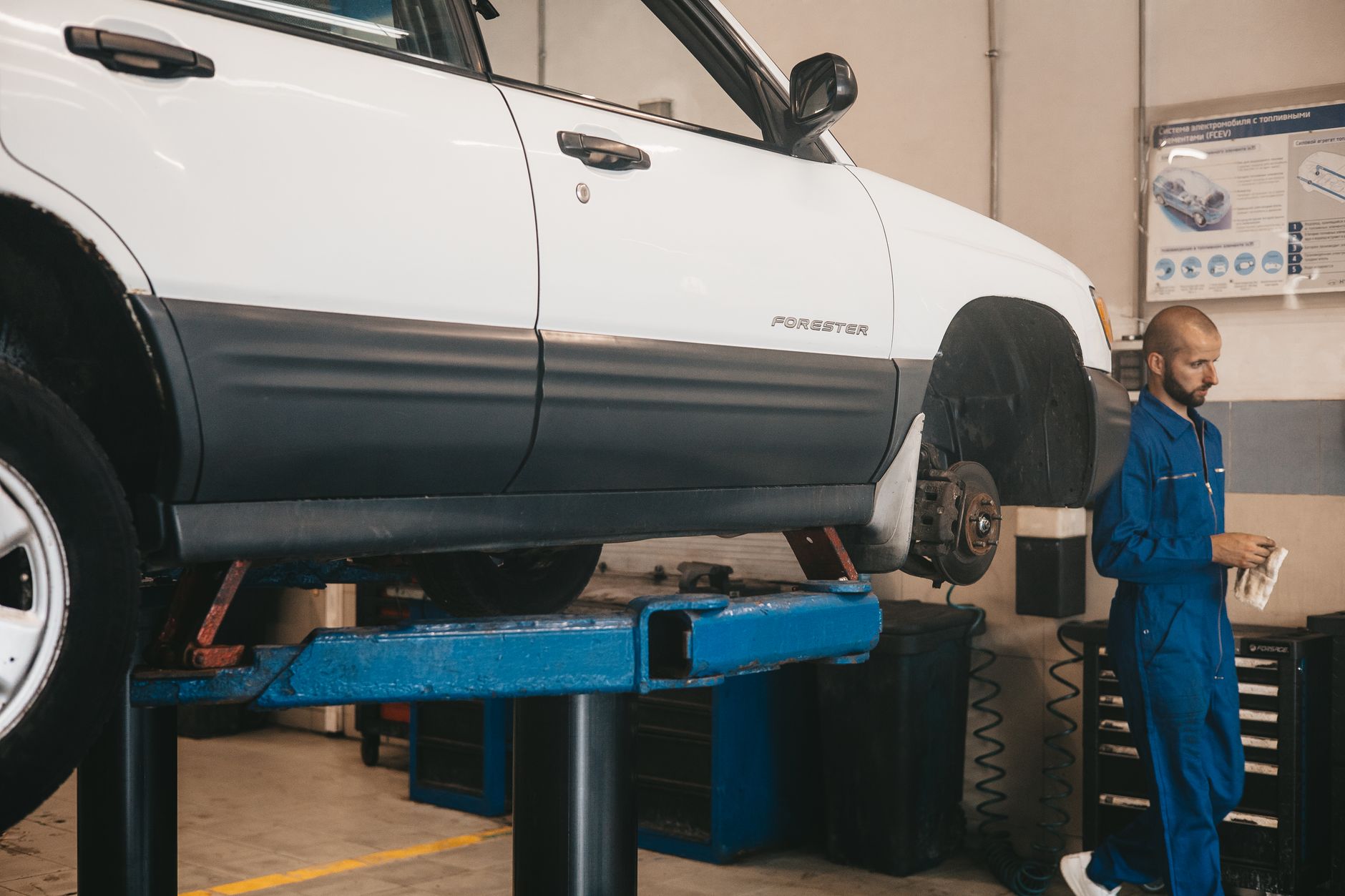 Automotive technician working on a vehicle in a professional service bay