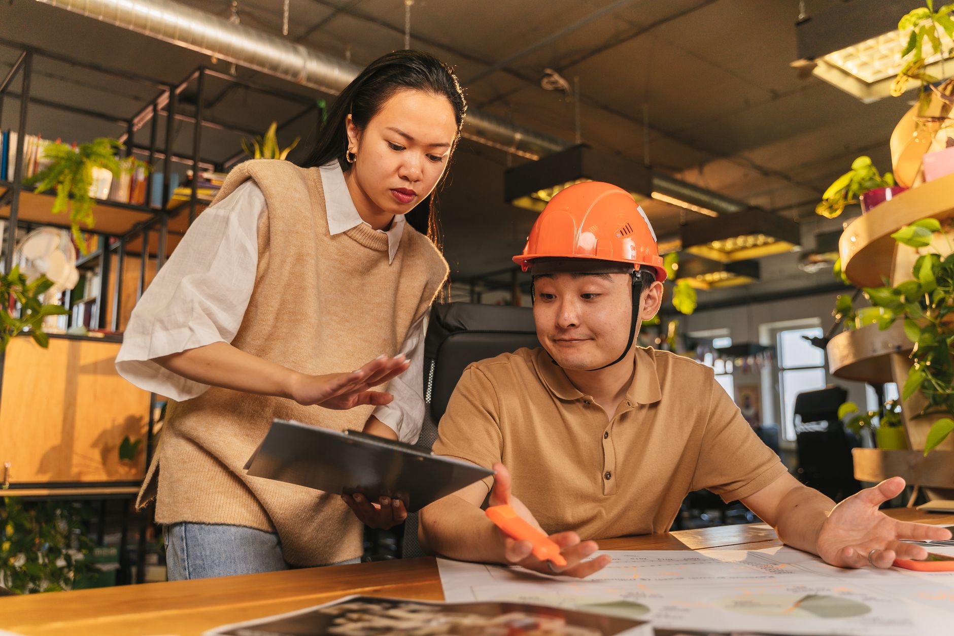 Engineers reviewing project documents in a modern office setting