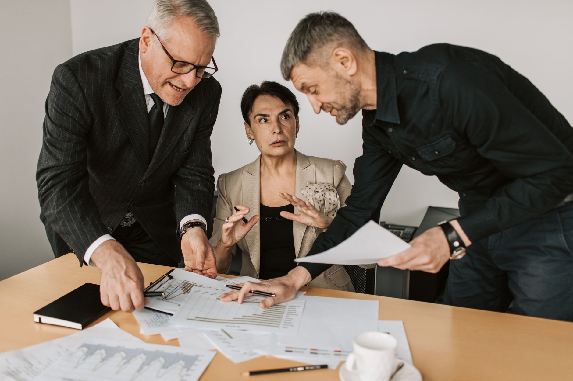 Business professionals reviewing financial documents in a conference room
