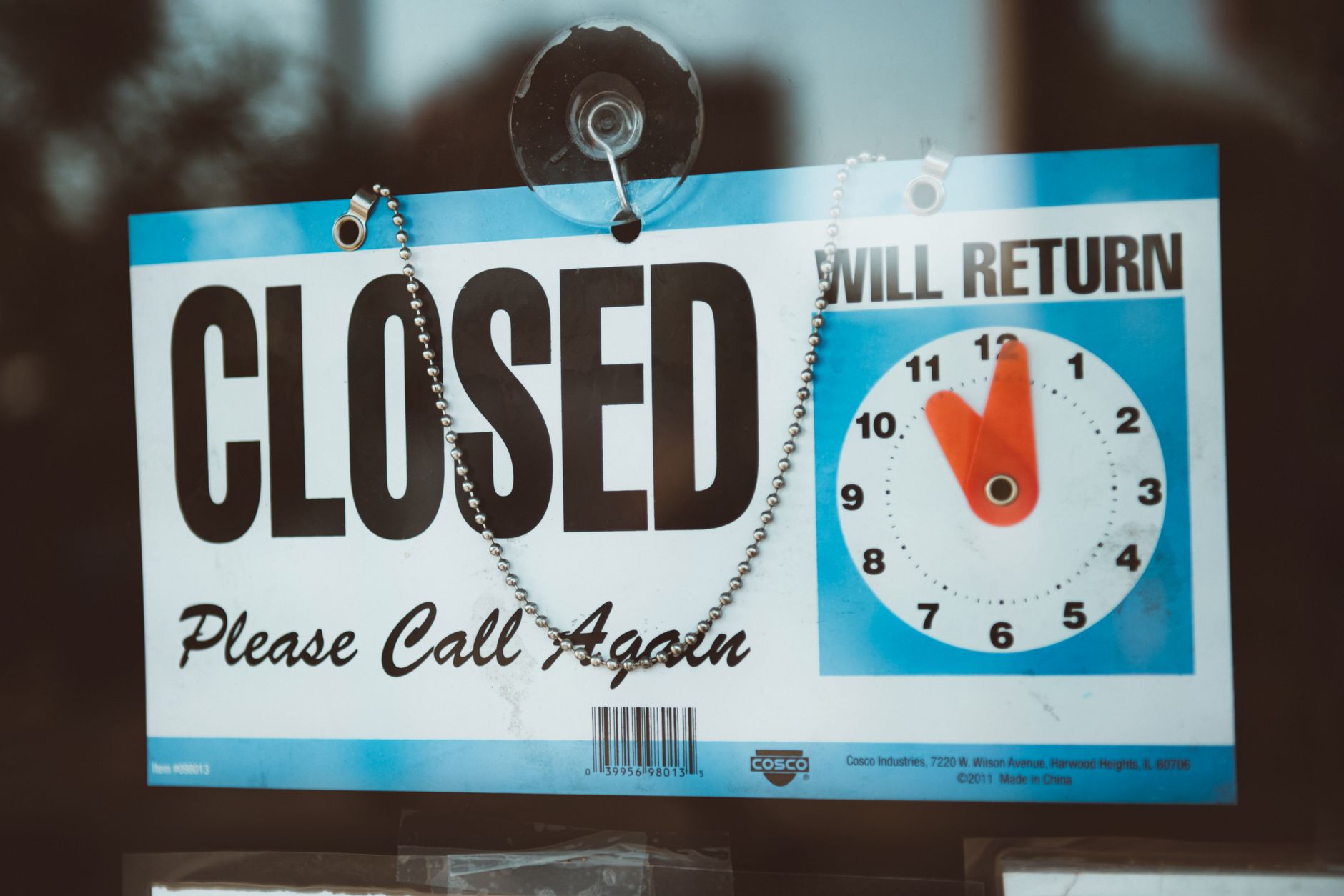 Vacant commercial space with darkened windows and a closed sign