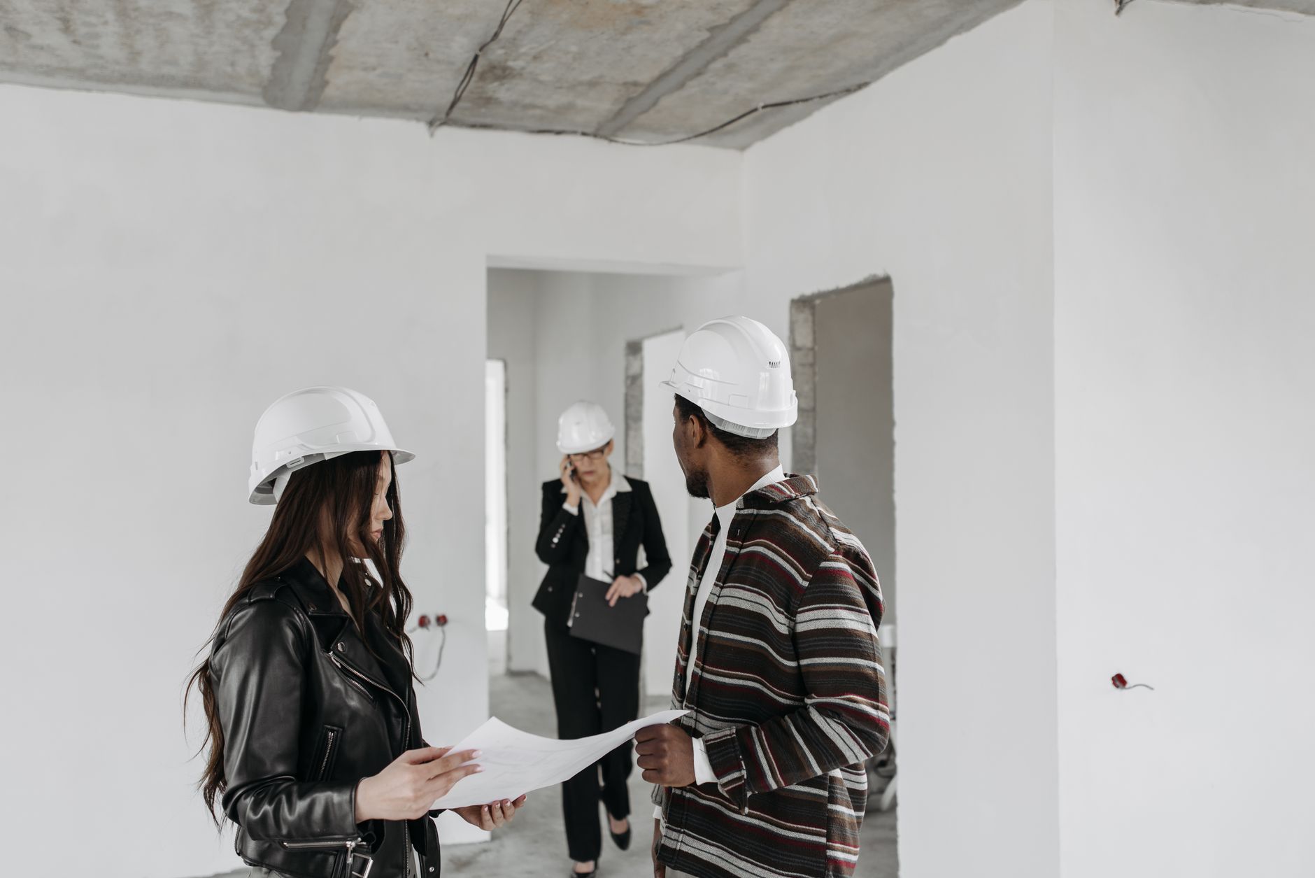 Contractor reviewing documents with a broker in a professional office setting
