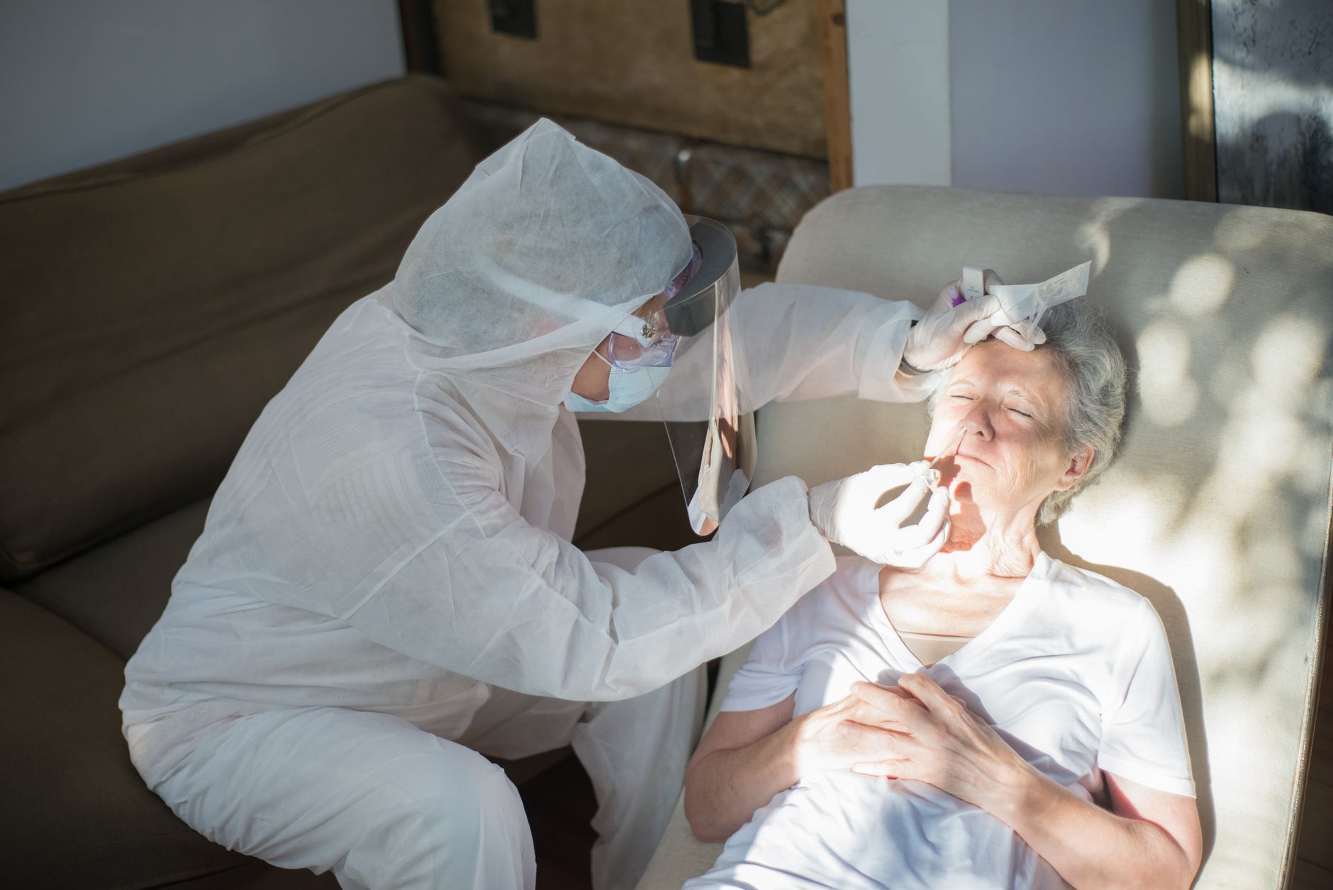 Home care nurse reviewing medication supply with patient during end-of-life hospice visit