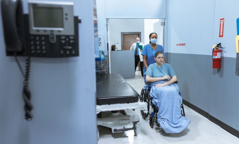 Empty hospital corridor representing healthcare system consolidation