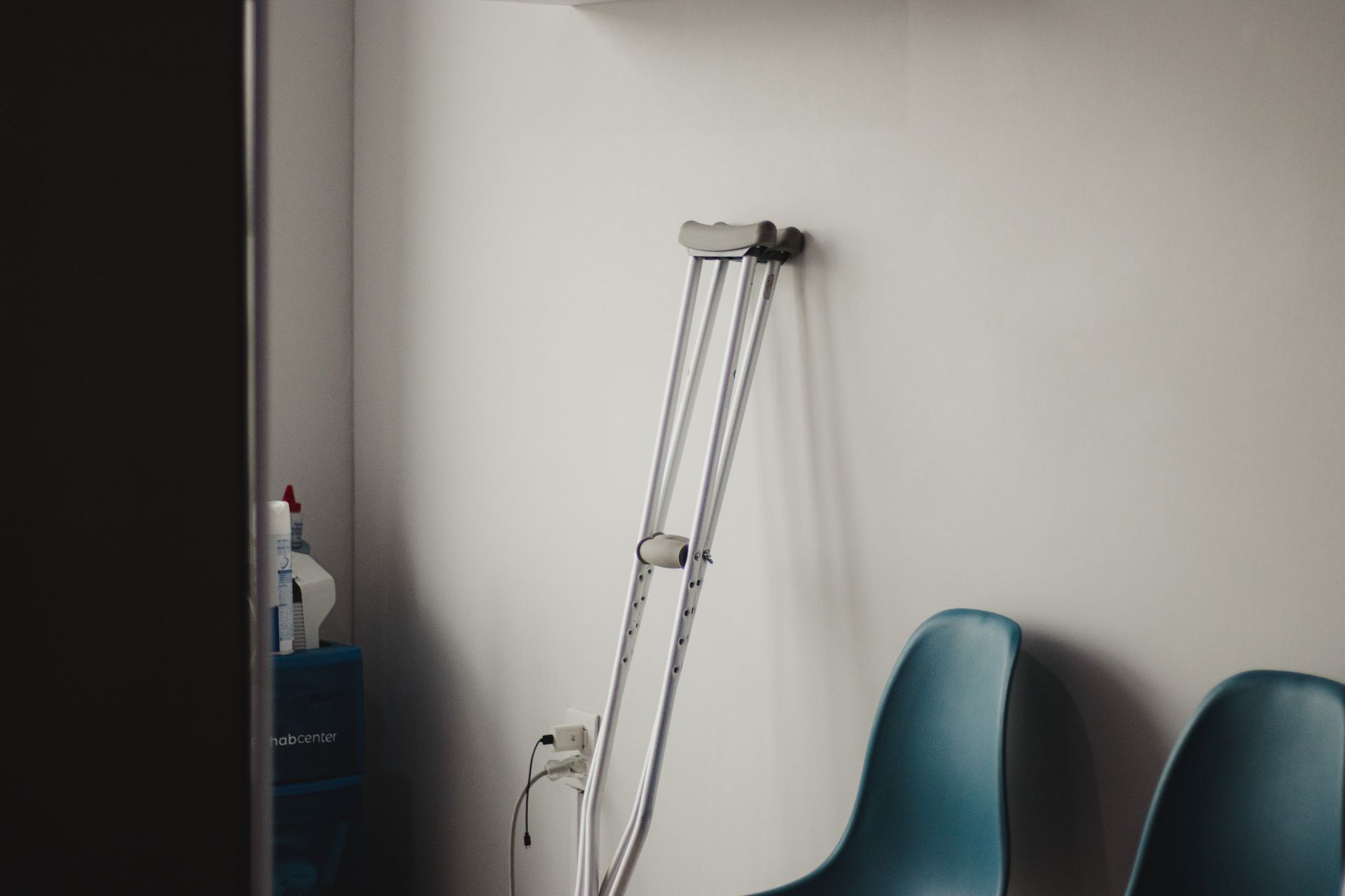 Empty fertility clinic waiting room with soft lighting and chairs