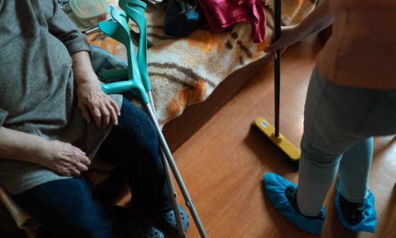 A caregiver sitting beside an elderly patient in a hospice setting