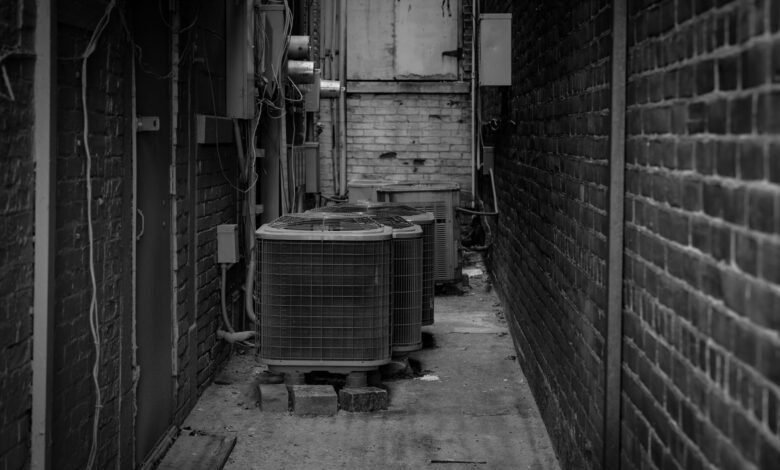HVAC technician working on an outdoor air conditioning unit