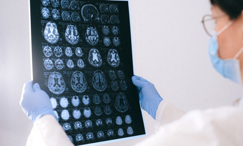 A radiologist reviewing medical imaging scans on a computer monitor in a clinical setting
