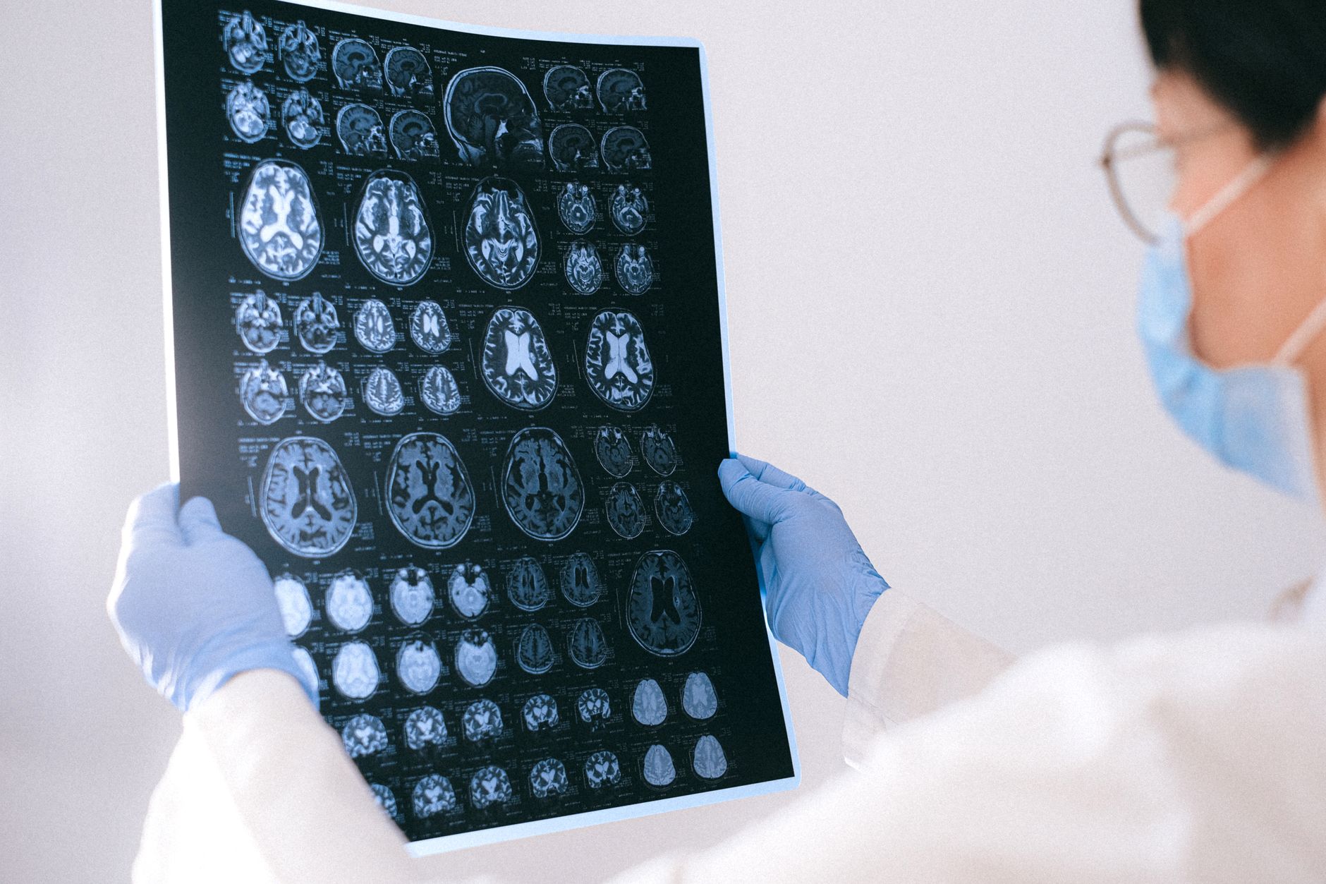 A radiologist reviewing medical imaging scans on a computer monitor in a clinical setting