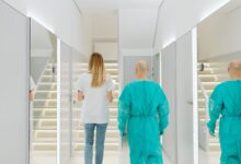 A clean, modern ambulatory surgery center corridor with medical equipment visible