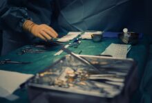 Empty operating room with anesthesia equipment and surgical lighting