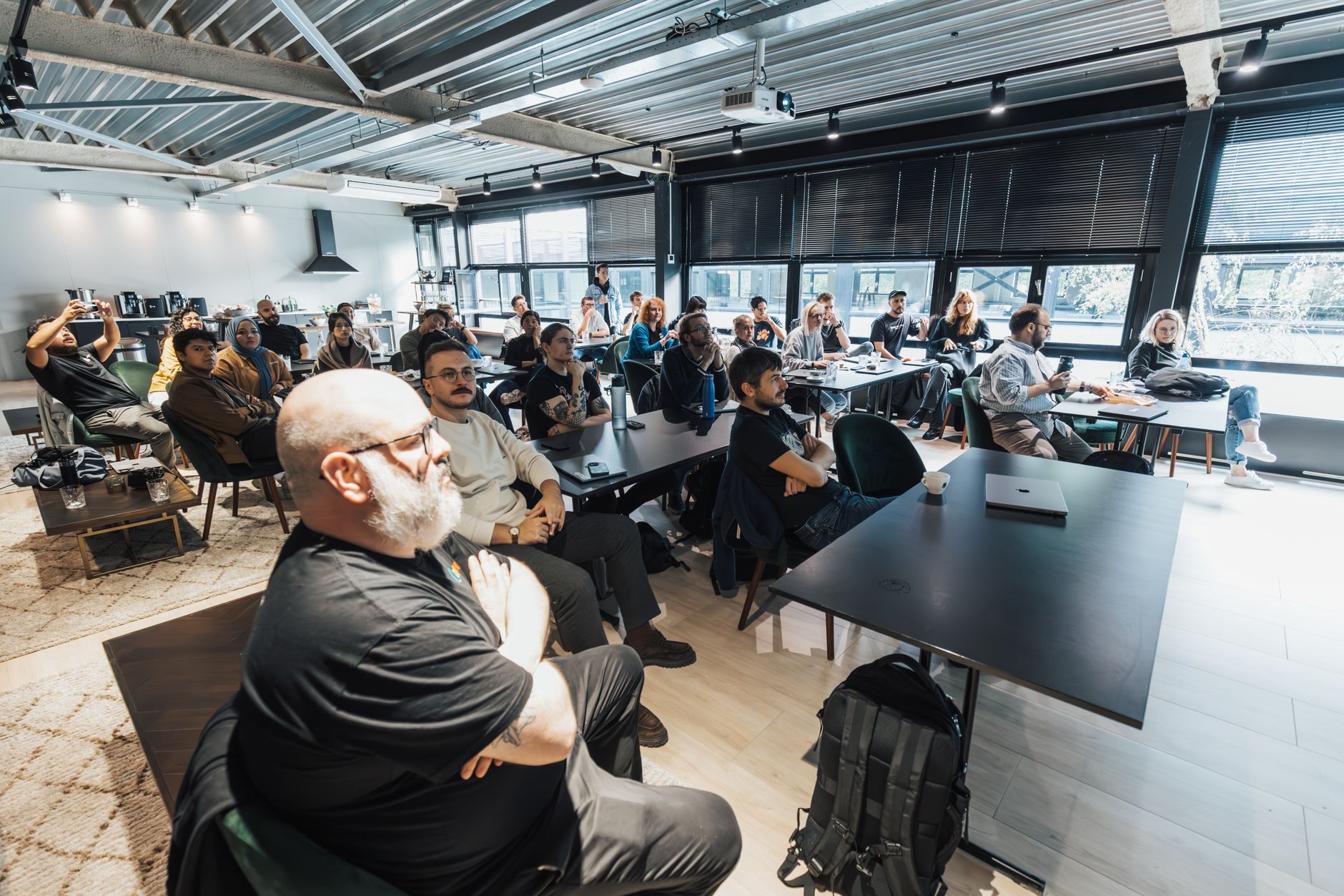 Business professionals in a corporate meeting room discussing acquisitions