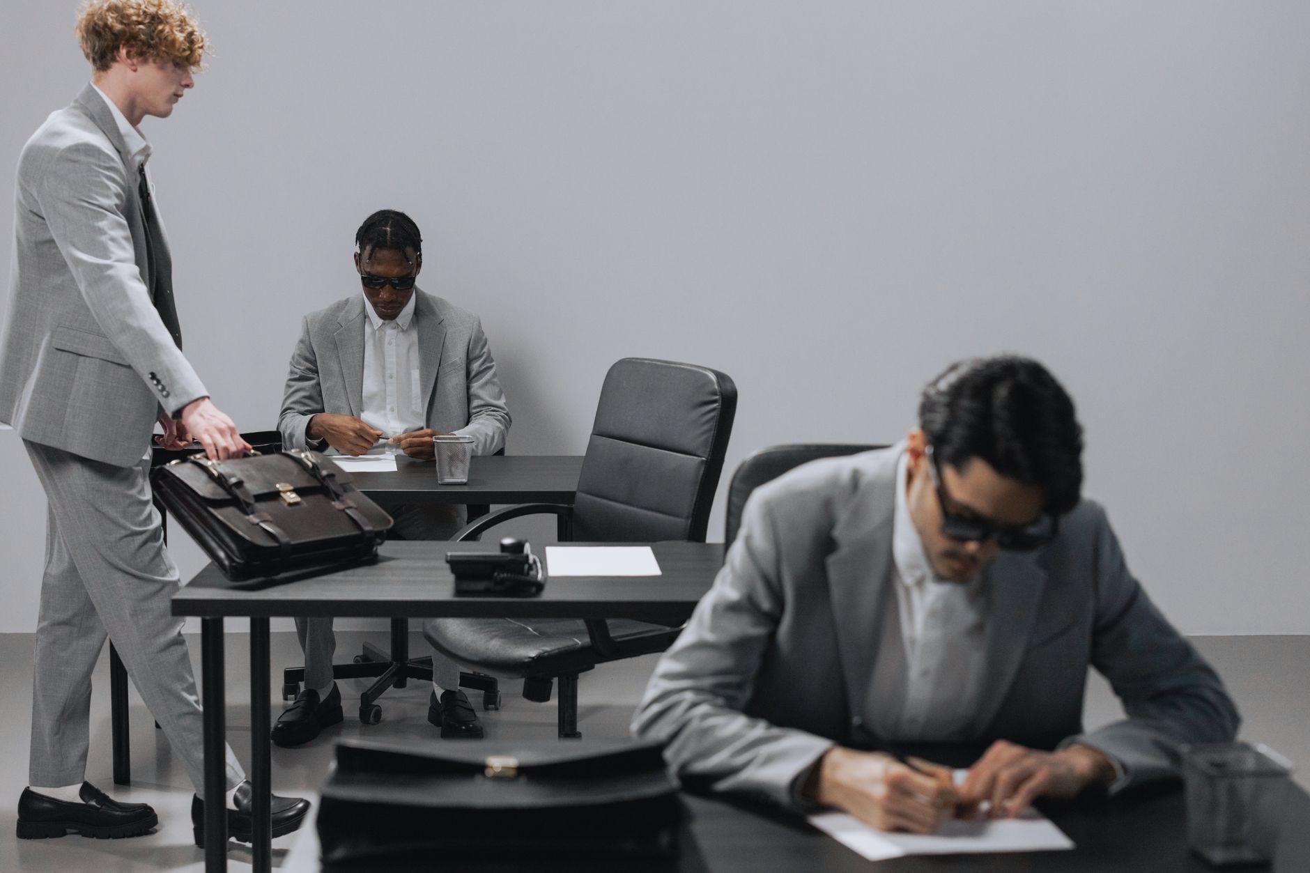 Professionals reviewing documents during a corporate acquisition meeting