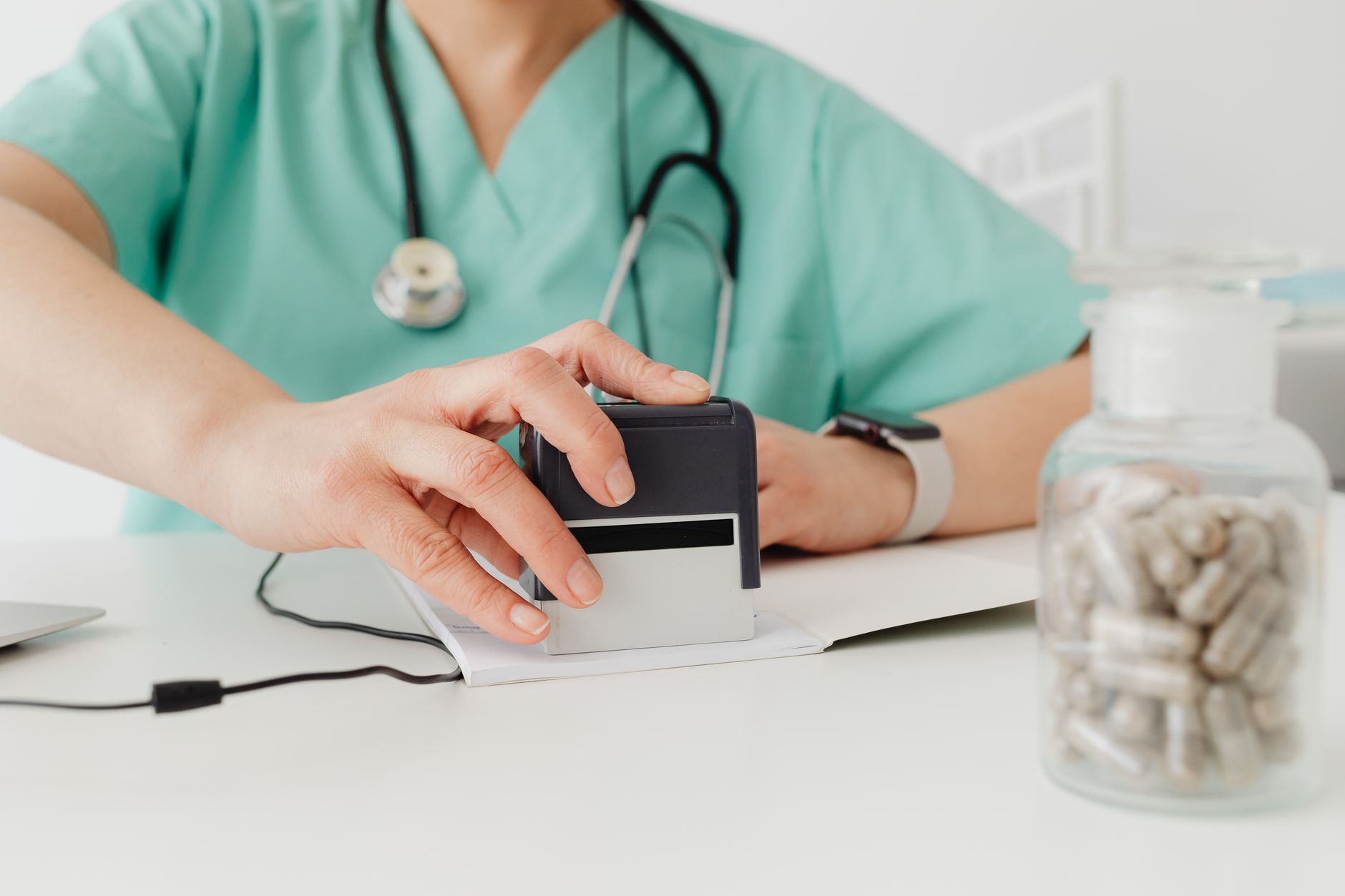 Healthcare billing staff reviewing insurance documents at a desk
