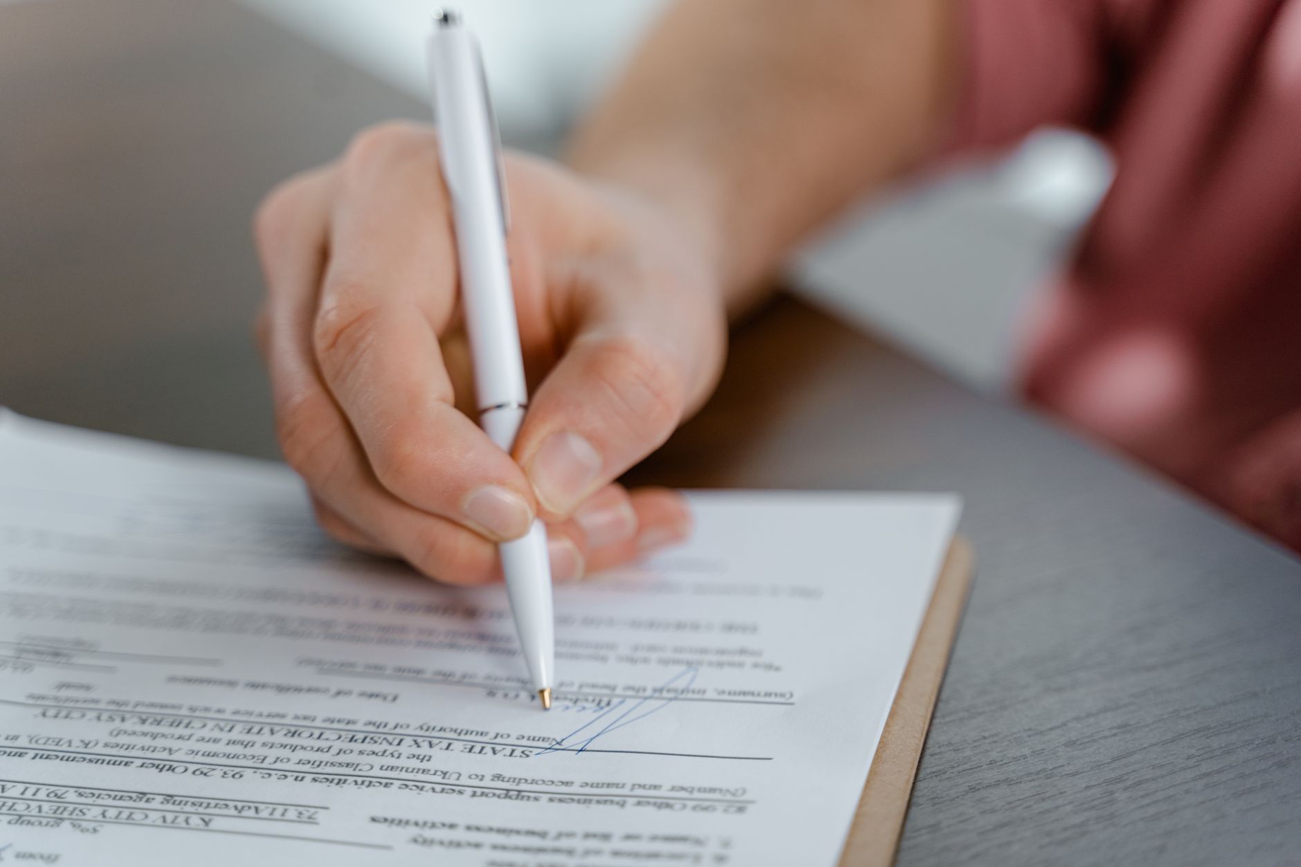 Two business professionals reviewing and signing an acquisition contract