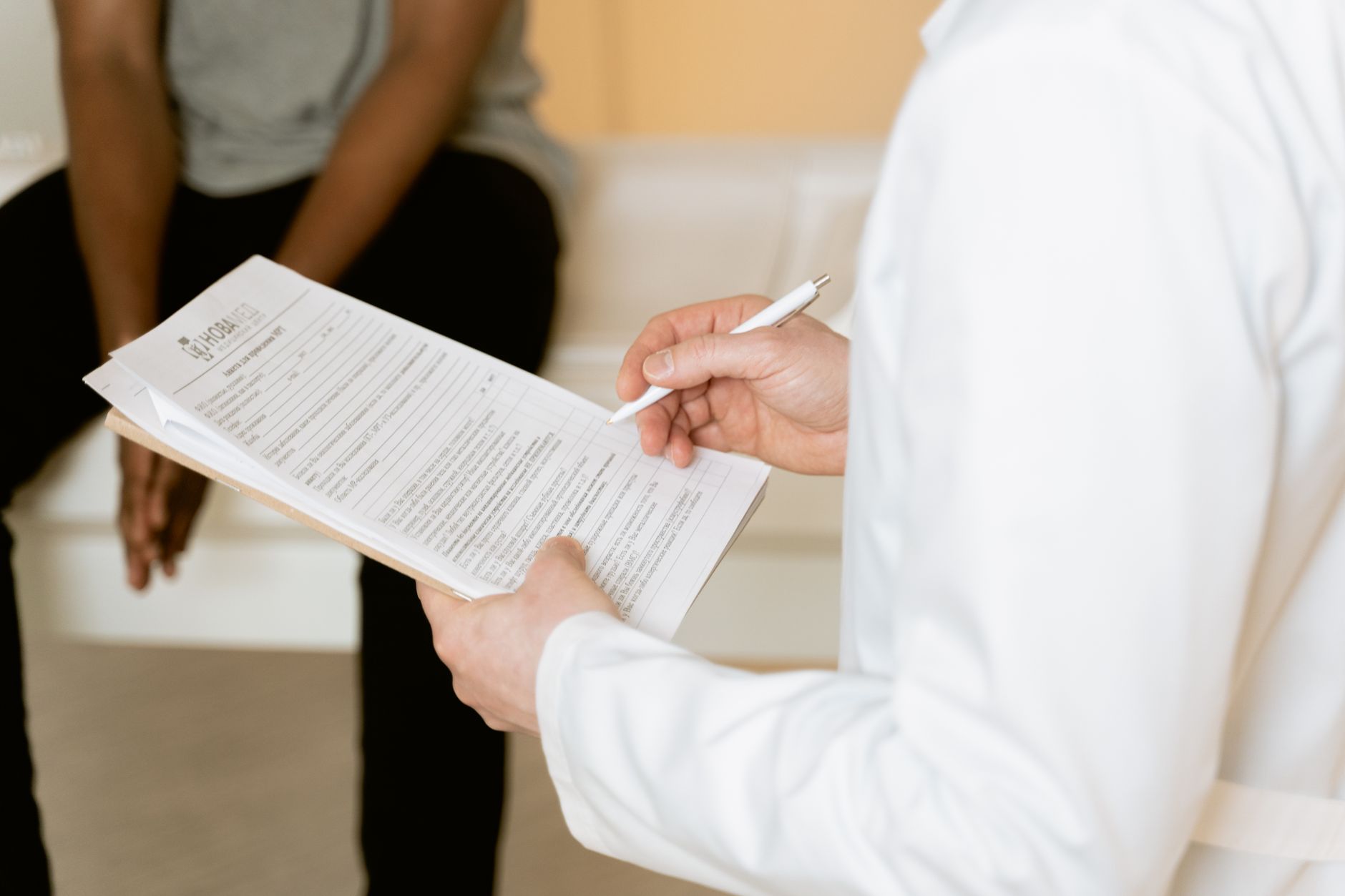 A physician reviewing and signing a contract document at a desk
