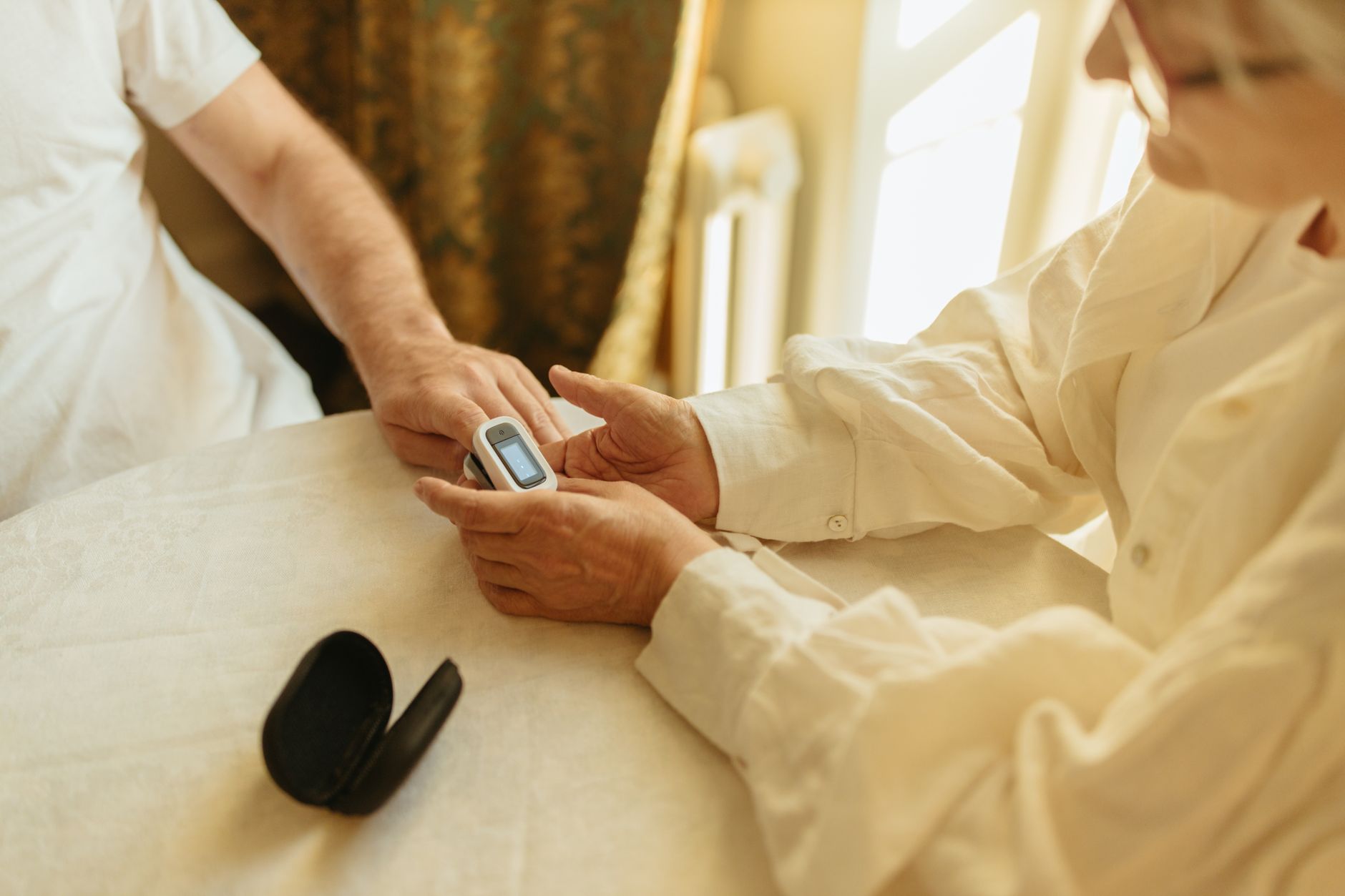 Elderly patient receiving home care from a medical professional