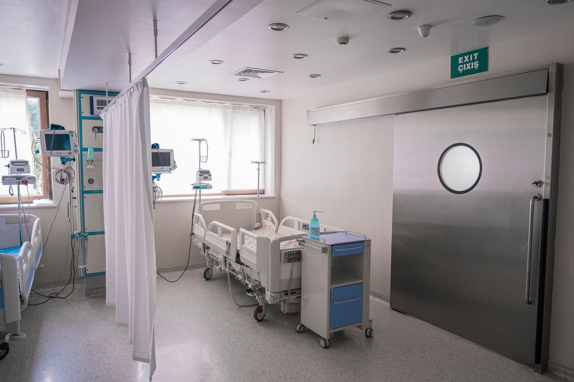 A quiet hospital corridor with medical staff walking in the background